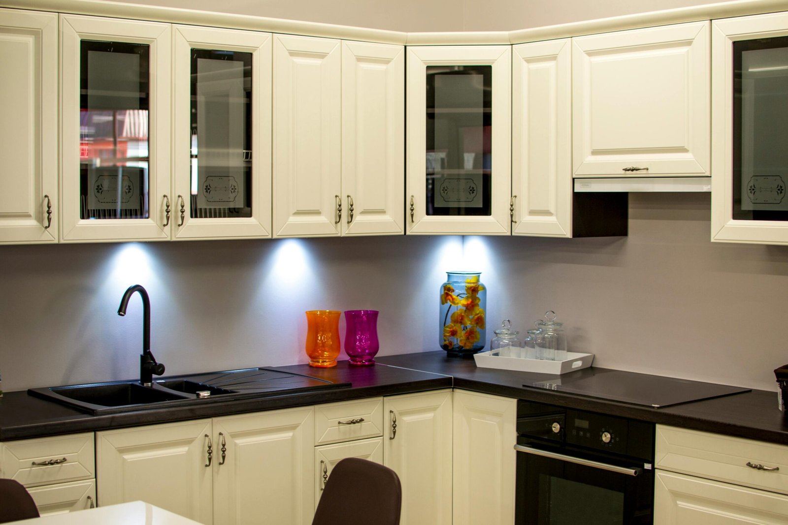 pexels-photo-94865-94865 A stylish modern kitchen with white cabinets and colorful decor pieces.